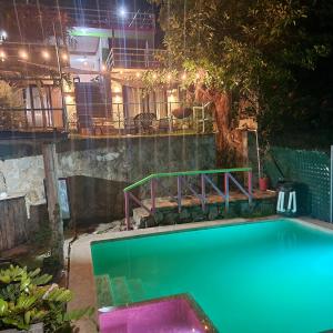 a swimming pool in a building at night at Restaurante y Hostal Romayor in El Congo
