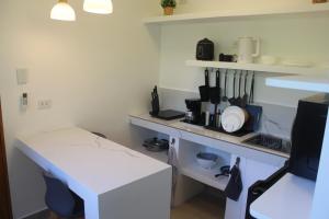 a small kitchen with a white counter and a table at Boracay Luxury Apartments in Boracay