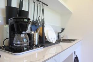 a kitchen counter with a coffee maker and utensils at Boracay Luxury Apartments in Boracay