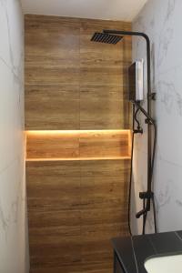 a shower with a wooden door in a bathroom at Boracay Luxury Apartments in Boracay