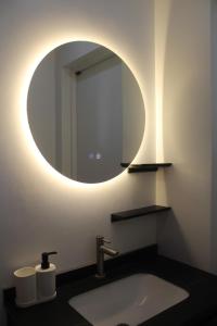 a bathroom with a sink and a mirror at Boracay Luxury Apartments in Boracay