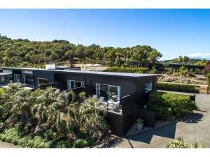 - une vue aérienne sur un bâtiment avec des palmiers dans l'établissement Delamore Cove - Kauri - Stay Waiheke, à Matiatia Bay