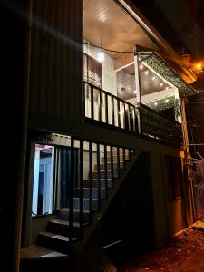 a staircase leading up to a building at night at Beautiful View House in Tortuguero