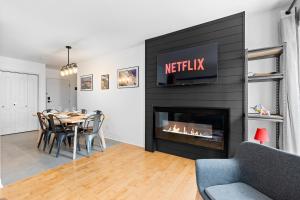 a dining room with a table and a fireplace at The redbull lodge with parking in Quebec City