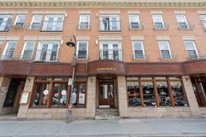 a store front of a building on a city street at The redbull lodge with parking in Quebec City
