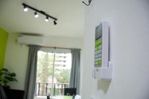 a television on the wall of a room with a window at Centro Apart Home in Jesús María