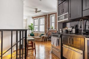 una cucina con lavandino e piano cottura forno superiore di Room at the heart of East Village 1 a New York