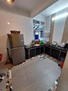 a kitchen is being remodeled with a refrigerator in it at Homestay rilex in Tanah Rata