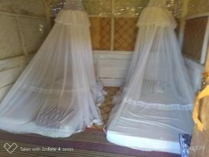 two beds with mosquito nets in a room at Tado Homestay in Limbung