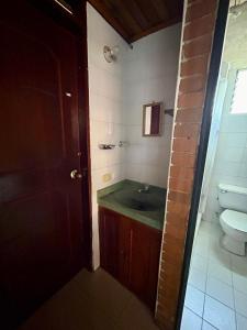 a bathroom with a sink and a toilet at El pinar, Dindalito in Bogotá