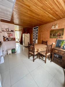 a kitchen with a table and chairs in a room at El pinar, Dindalito in Bogotá