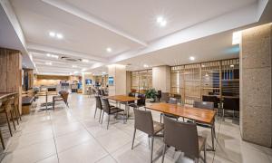 a dining room with tables and chairs in a building at Dongdaegu Station Eastern Hotel in Daegu