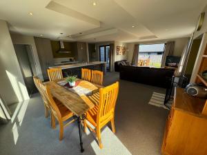 a kitchen and dining room with a wooden table and chairs at 7a Coleridge Street in Hanmer Springs