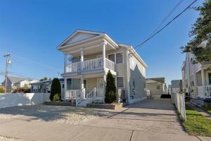 a white house with a balcony on a street at Cozy and Quiet- Seaview Avenue in Wildwood Crest in Wildwood
