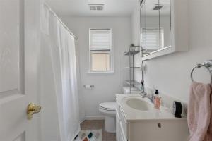 a white bathroom with a sink and a toilet at Cozy and Quiet- Seaview Avenue in Wildwood Crest in Wildwood