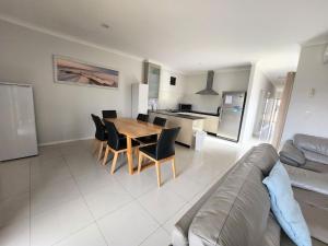 a kitchen and living room with a table and chairs at Unit 26 Seafront Estate in Jurien Bay
