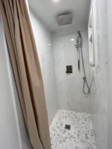 a bathroom with a shower with a shower curtain at 49 Hostel in Toronto