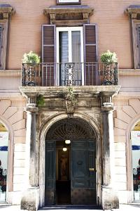 an entrance to a building with a balcony and a door at Corso 12 Roma in Rome