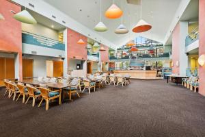 a dining area with tables and chairs in a cafeteria at Quality Hotel Manor in Mitcham