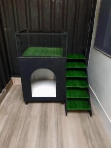 une maison pour chiens noirs avec des escaliers verts dans une chambre dans l'établissement casa com bela vista em itatiba, à Bragança Paulista