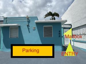 a blue building with a palm tree on top of it at C&C Studio in San Juan