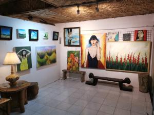 a room with many paintings on the wall at La Vida Hostel Samal Island in Samal