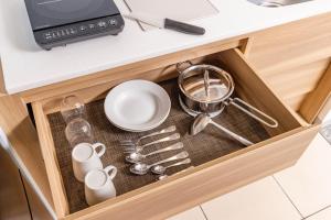 a drawer in a kitchen with dishes and utensils at Tokyu Stay Meguro Yutenji in Tokyo