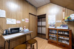 a kitchen with a counter with a microwave at Hostel みんか松本 in Matsumoto