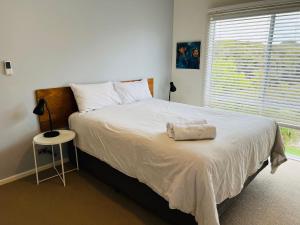 a bedroom with a large bed with a white blanket at Salt Life - Pet Friendly Outside WIFI in Robe
