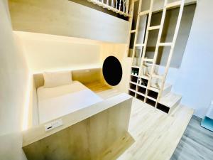 a small room with a bed and a staircase at Beachcastle & Sea View Villa in Magong