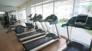 a gym with cardio machines and a large window at Mivesa Chic Studio + fast wifi in Cebu City