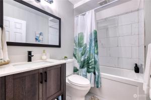a bathroom with a toilet and a sink and a bath tub at Newly Remodeled 2Bd Room A Frame Cottage Point Roberts in Point Roberts