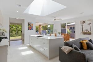 an open kitchen and living room with a couch at Cowes Family Beach House in Cowes