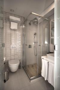 a bathroom with a shower and a toilet and a sink at Istanbul Town Hotel in Istanbul