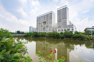 a city with tall buildings next to a body of water at Lena Condotel in Ho Chi Minh City