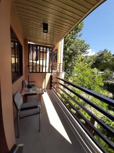 a balcony of a house with a table and chairs at MKB Pension in Coron