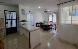 a kitchen and living room with a table and a dining room at Casa Nuevo México in Mérida +6 photos