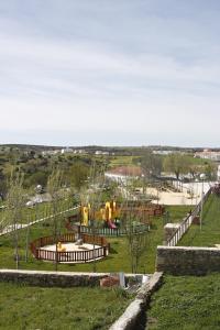 a park with a playground with a slide at Casa da Avó Ilda in Miranda do Douro