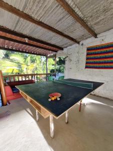 a ping pong table in the middle of a room at Jurema Camping in Itacaré