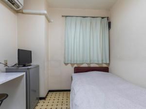 Postel nebo postele na pokoji v ubytování Business Hotel Kaga