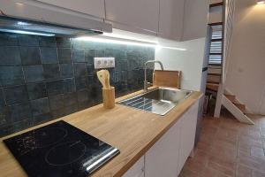 a kitchen with a sink and a counter top at 26 Casa dos Miúdos - Alfarim in Sesimbra +31 photos