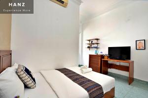a hotel room with two beds and a television at HANZ Hotel upstair MPChill in Ho Chi Minh City
