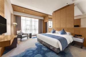 En eller flere senge i et værelse på FLIPORT Hotel Xiamen Software Park