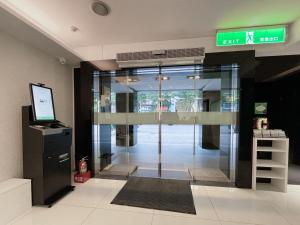 wejście do budynku ze szklanymi drzwiami w obiekcie CHECK inn Express Taipei Yongkang w Tajpej
