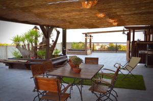 a wooden table and chairs on a patio at B&B Terrazza dell'Etna in Mascalucia