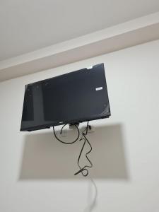 a flat screen tv sitting on top of a table at LIRI House in Oxapampa