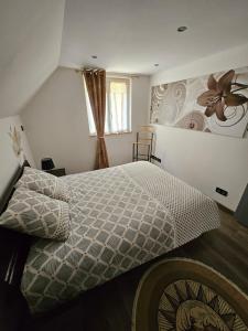 a bedroom with a king sized bed with a flower mural at Gîte Vallée de Munster chez Flavie & Ludo in Muhlbach-sur-Munster