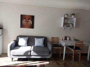 a living room with a couch and a table at Sweet Home by the Golf Course in Canberra