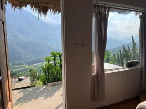 a room with a window with a view of a mountain at Pavi home in Sa Pa