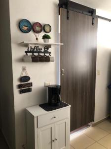 a kitchen with a counter with a coffee maker on it at Mistic hills in Panama City